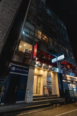 a building with a sign on the front of it at Guesthouse Akasaka in Tokyo