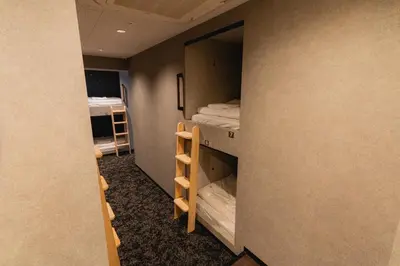 a small room with two bunk beds in it at Guesthouse Akasaka in Tokyo