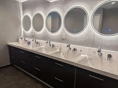 a bathroom with three sinks and three mirrors at Guesthouse Akasaka in Tokyo