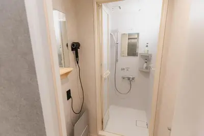 a bathroom with a shower and a sink at Guesthouse Akasaka in Tokyo