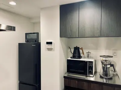 a kitchen with a black refrigerator and a microwave at Alo BnB 9 - Near ROPPONGI, GINZA, SHINJUKU, SHIBUYA - Self check-in in Tokyo