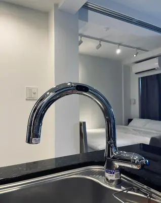 a kitchen sink with a mirror and a bed at Alo BnB 9 - Near ROPPONGI, GINZA, SHINJUKU, SHIBUYA - Self check-in in Tokyo