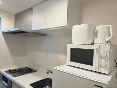 a kitchen with a microwave on top of a refrigerator at Shinjuku Kabukichō-4F-SJ0013 in Tokyo