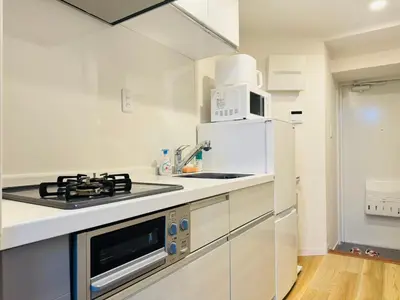 a white kitchen with a sink and a microwave at Shinjuku Kabukichō-4F-SJ0013 in Tokyo