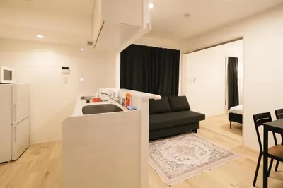 a kitchen with a sink and a black couch at Apb \u4e24\u56fd in Tokyo