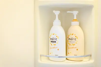 two bottles of milk are sitting in a refrigerator at Luna House in Tokyo