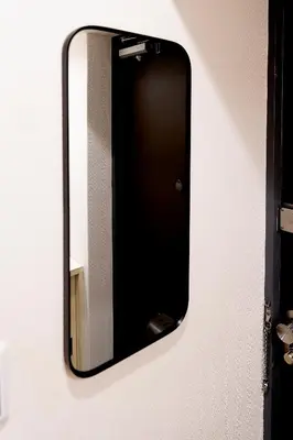 a mirror hanging on a wall with at Zen apartment in central Tokyo in Tokyo