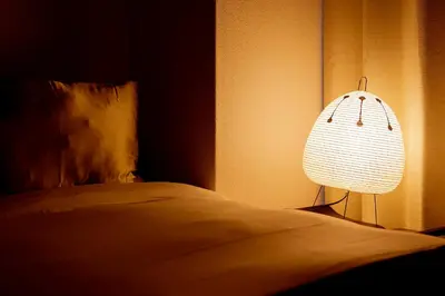 a bedroom with a bed with a lamp next to it at Zen apartment in central Tokyo in Tokyo