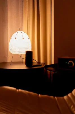 a lamp sitting on a table next to a couch at Zen apartment in central Tokyo in Tokyo