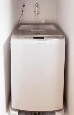 a white washing machine sitting in a room at Zen apartment in central Tokyo in Tokyo