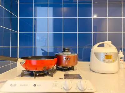 a red pot on a stove in a kitchen at Pangoo Shinagawa Room 104 - Vacation STAY 97800v in Tokyo