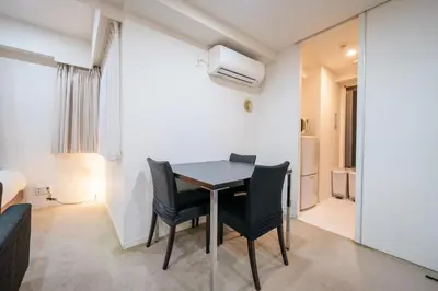 a dining room with a table and chairs in a room at Pangoo Shinagawa Room 104 - Vacation STAY 97800v in Tokyo
