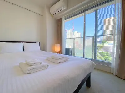 a bedroom with a white bed with towels on it at Pangoo Shinagawa Room 201 - Vacation STAY 98556v in Tokyo