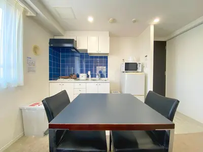 a kitchen with a table and chairs in a room at Pangoo Shinagawa Room 201 - Vacation STAY 98556v in Tokyo