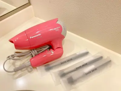 a pink hair dryer sitting on a counter with three knives at Pangoo Shinagawa Room 201 - Vacation STAY 98556v in Tokyo