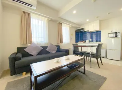 a living room with a couch and a table at Pangoo Shinagawa Room 201 - Vacation STAY 98556v in Tokyo