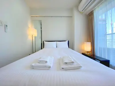 a bedroom with a white bed with two towels on it at Pangoo Shinagawa Room 201 - Vacation STAY 98556v in Tokyo