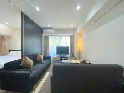 a room with a couch and a bed and a television at Pangoo Shinagawa Room 204 - Vacation STAY 98612v in Tokyo
