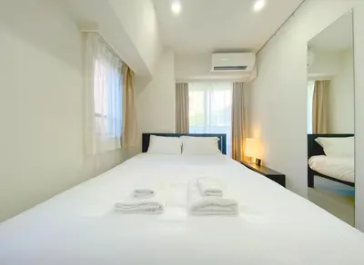 a bedroom with a white bed with two towels on it at Pangoo Shinagawa Room 204 - Vacation STAY 98612v in Tokyo