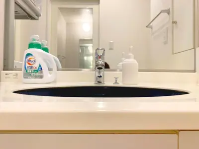 a bathroom sink with a bottle of soap and a mirror at Pangoo Shinagawa Room 204 - Vacation STAY 98612v in Tokyo