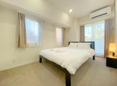 a large white bed in a room with windows at Pangoo Shinagawa Room 204 - Vacation STAY 98612v in Tokyo