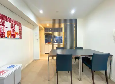 a dining room with a table and blue chairs at Pangoo Shinagawa Room 204 - Vacation STAY 98612v in Tokyo