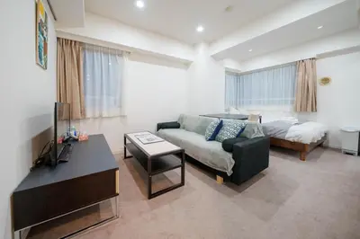 a living room with a couch and a bed at Pangoo Shinagawa Room 205 - Vacation STAY 18364 in Tokyo
