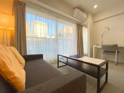 a living room with a couch and a table at Pangoo Shinagawa Room 303 - Vacation STAY 99296v in Tokyo