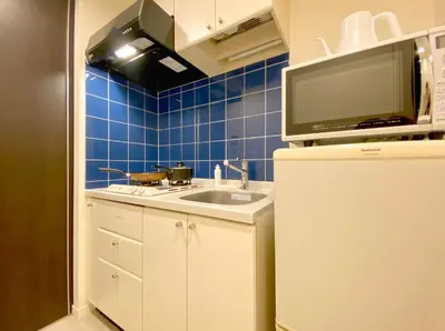 a small kitchen with a sink and a microwave at Pangoo Shinagawa Room 304 - Vacation STAY 18366 in Tokyo