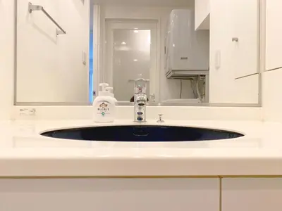 a sink in a white bathroom with a mirror at Pangoo Shinagawa Room 304 - Vacation STAY 18366 in Tokyo
