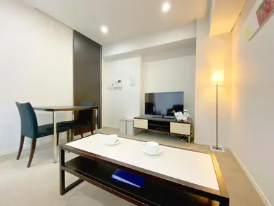a living room with a table and a tv at Pangoo Shinagawa Room 306 - Vacation STAY 18372 in Tokyo