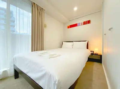 a large white bed in a room with a window at Pangoo Shinagawa Room 306 - Vacation STAY 18372 in Tokyo