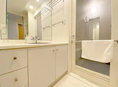 a white bathroom with a shower and a sink at Pangoo Shinagawa Room 401 - Vacation STAY 99346v in Tokyo