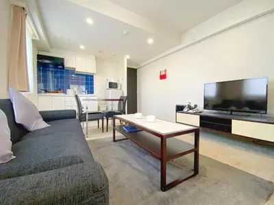 a living room with a couch and a table at Pangoo Shinagawa Room 401 - Vacation STAY 99346v in Tokyo