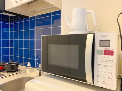 a microwave sitting on top of a kitchen counter at Pangoo Shinagawa Room 402 - Vacation STAY 99354v in Tokyo