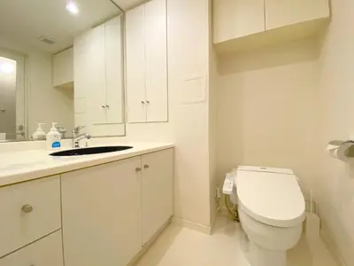 a white bathroom with a toilet and a sink at Pangoo Shinagawa Room 403 - Vacation STAY 99365v in Tokyo