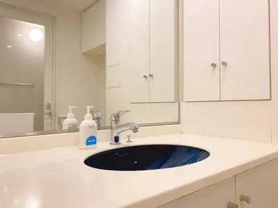 a white bathroom with a sink and a mirror at Pangoo Shinagawa Room 403 - Vacation STAY 99365v in Tokyo