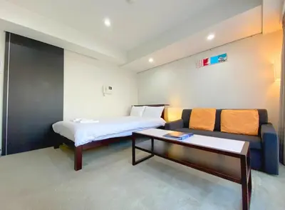 a hotel room with a bed and a couch at Pangoo Shinagawa Room 403 - Vacation STAY 99365v in Tokyo