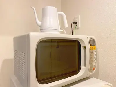 a white microwave with a cup on top of it at Pangoo Shinagawa Room 403 - Vacation STAY 99365v in Tokyo