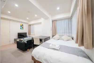 a bedroom with a bed and a desk with a computer at Pangoo Shinagawa Room 405 - Vacation STAY 18374 in Tokyo