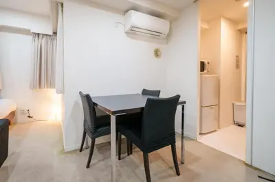 a dining room with a table and chairs at Pangoo Shinagawa Room 405 - Vacation STAY 18374 in Tokyo