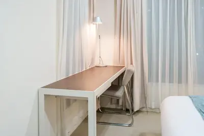 a desk in a hotel room with a bed and a lamp at Pangoo Shinagawa Room 405 - Vacation STAY 18374 in Tokyo