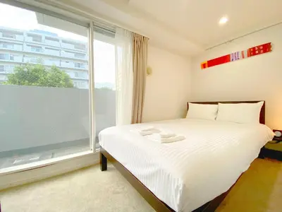 a bedroom with a bed and a large window at Pangoo Shinagawa Room 406 - Vacation STAY 18375 in Tokyo