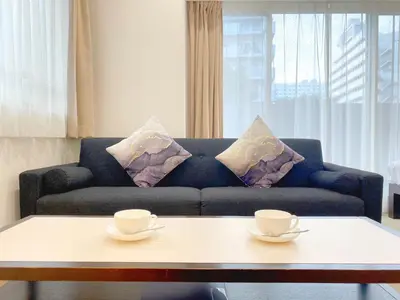 a living room with a couch and two cups on a table at Pangoo Shinagawa Room 406 - Vacation STAY 18375 in Tokyo