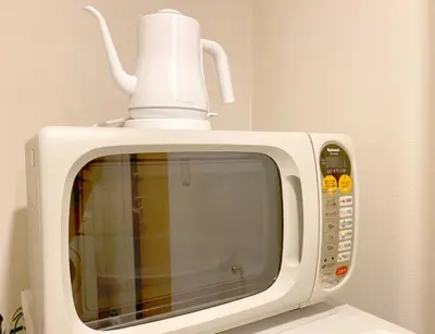 a white microwave with a coffee pot on top of it at Pangoo Shinagawa Room 406 - Vacation STAY 18375 in Tokyo