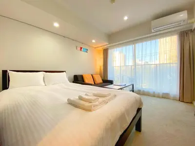 a bedroom with a large bed with towels on it at Pangoo Shinagawa Room 503 - Vacation STAY 00026v in Tokyo