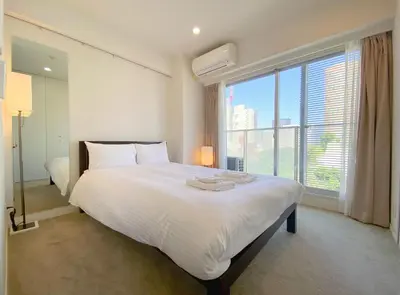 a bedroom with a large bed and a large window at Pangoo Shinagawa Room 601 - Vacation STAY 00052v in Tokyo