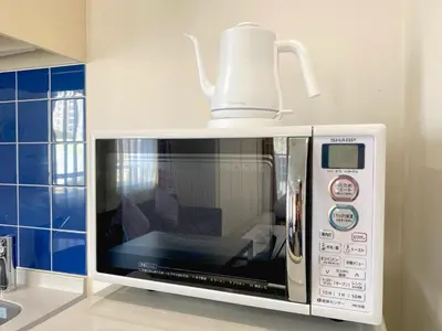 a microwave with a coffee pot on top of it at Pangoo Shinagawa Room 601 - Vacation STAY 00052v in Tokyo