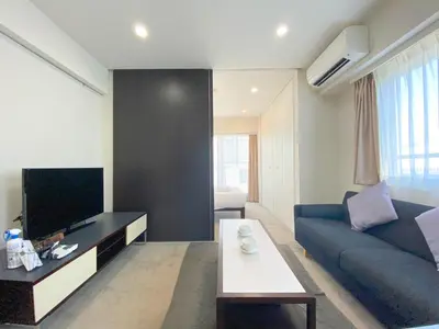 a living room with a blue couch and a tv at Pangoo Shinagawa Room 601 - Vacation STAY 00052v in Tokyo