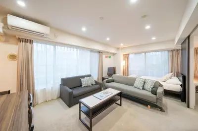 a living room with a couch and a chair at angoo Shinagawa Room 603 - Vacation STAY 00071v in Tokyo